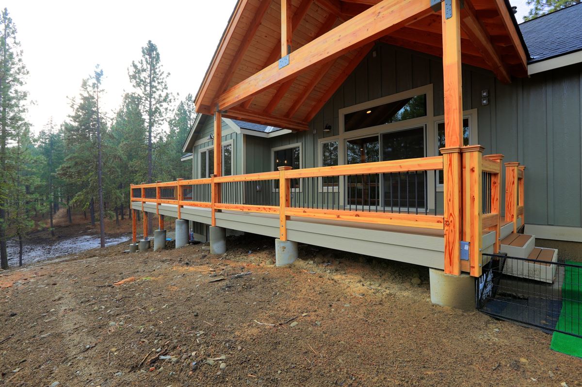 View of a spacious walkout deck with wooden railing